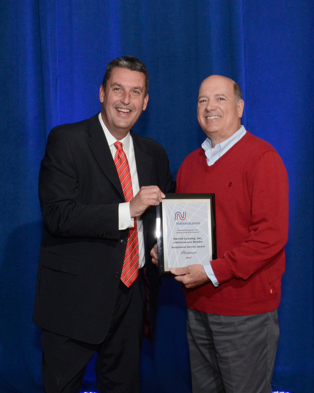 NationaLease President Dean Vicha presents the Exceptional Service Award to Chuck Miller of Parrish Leasing, Inc., a NationaLease Member